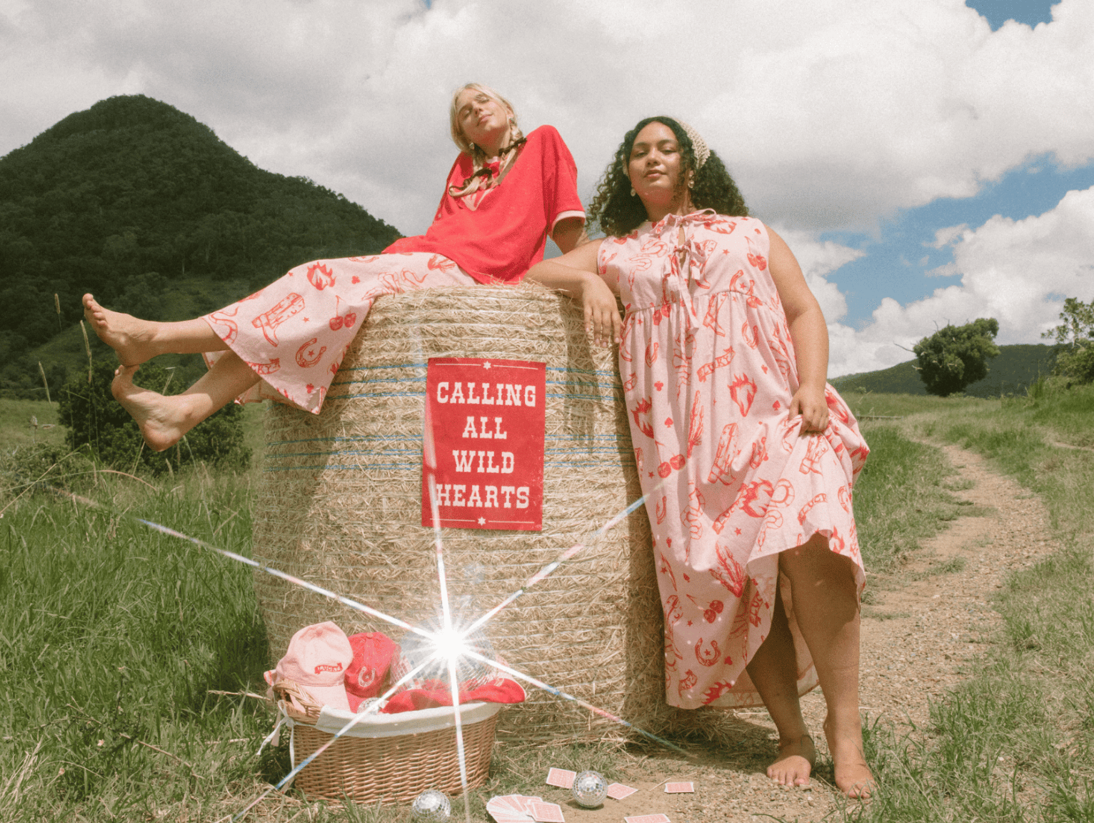 Three women wearing linen printed sets, relaxed sitting on stairs outside in a fashionable manner