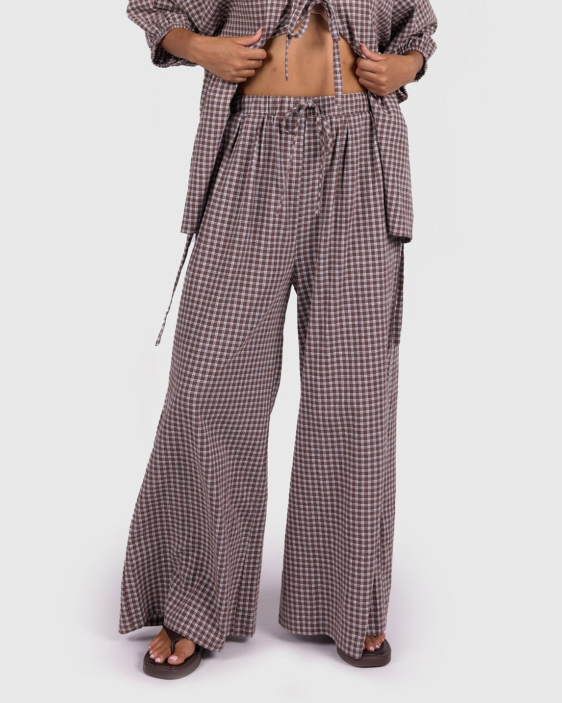 Woman wearing a checkered outfit on a white background