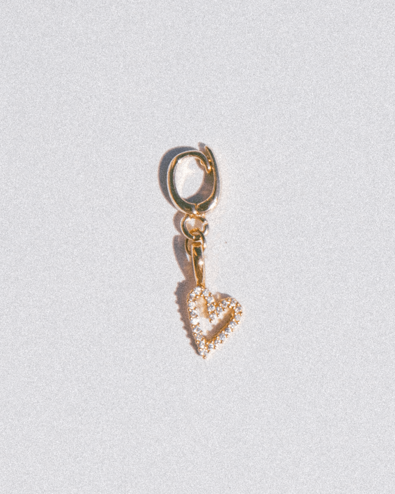 Gold outlined heart charm with diamonds