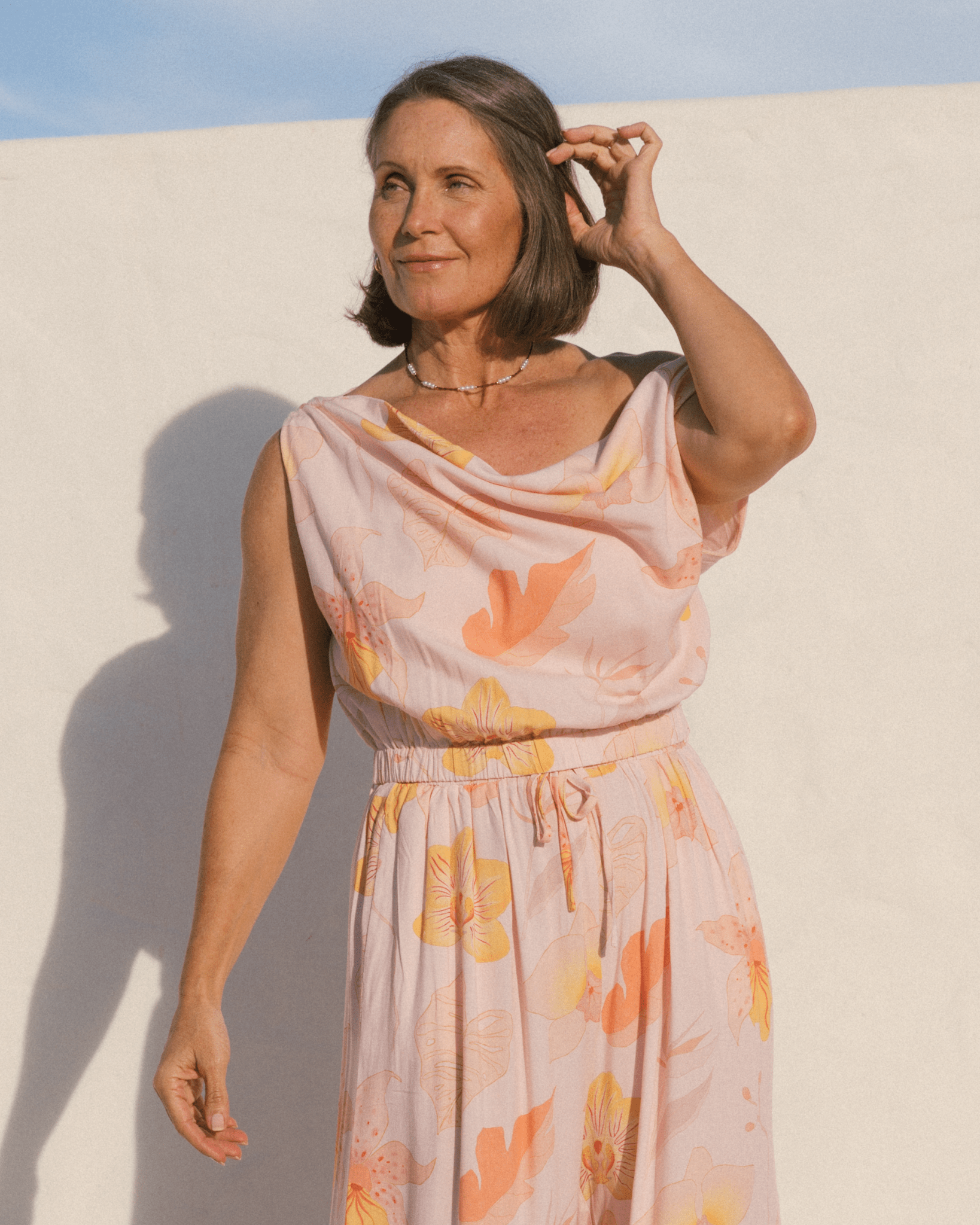 Woman wearing a breathable light pink floral spring co-ord set.