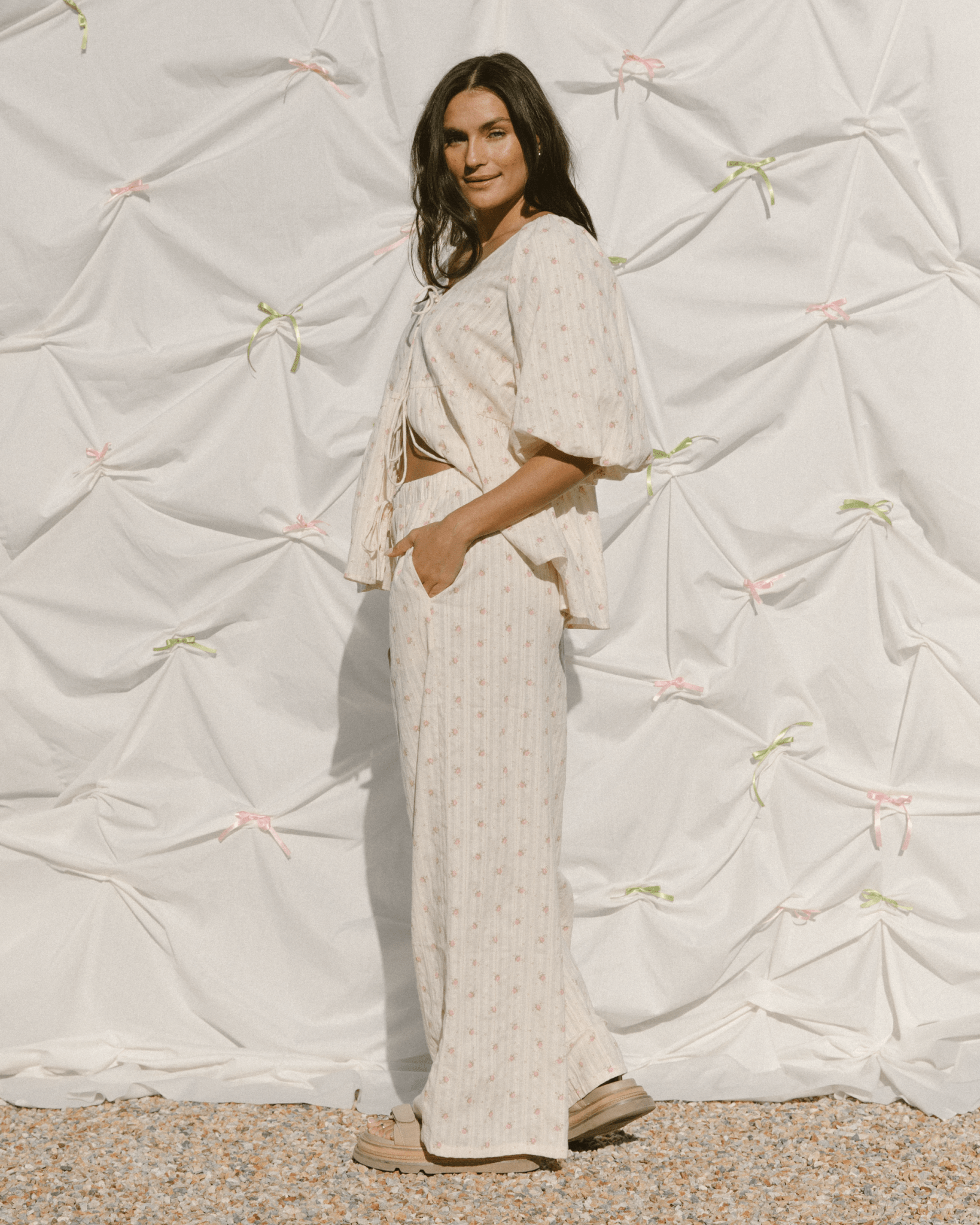 Woman wearing relaxed cottage-core inspired outfit with a whimsical floral print.