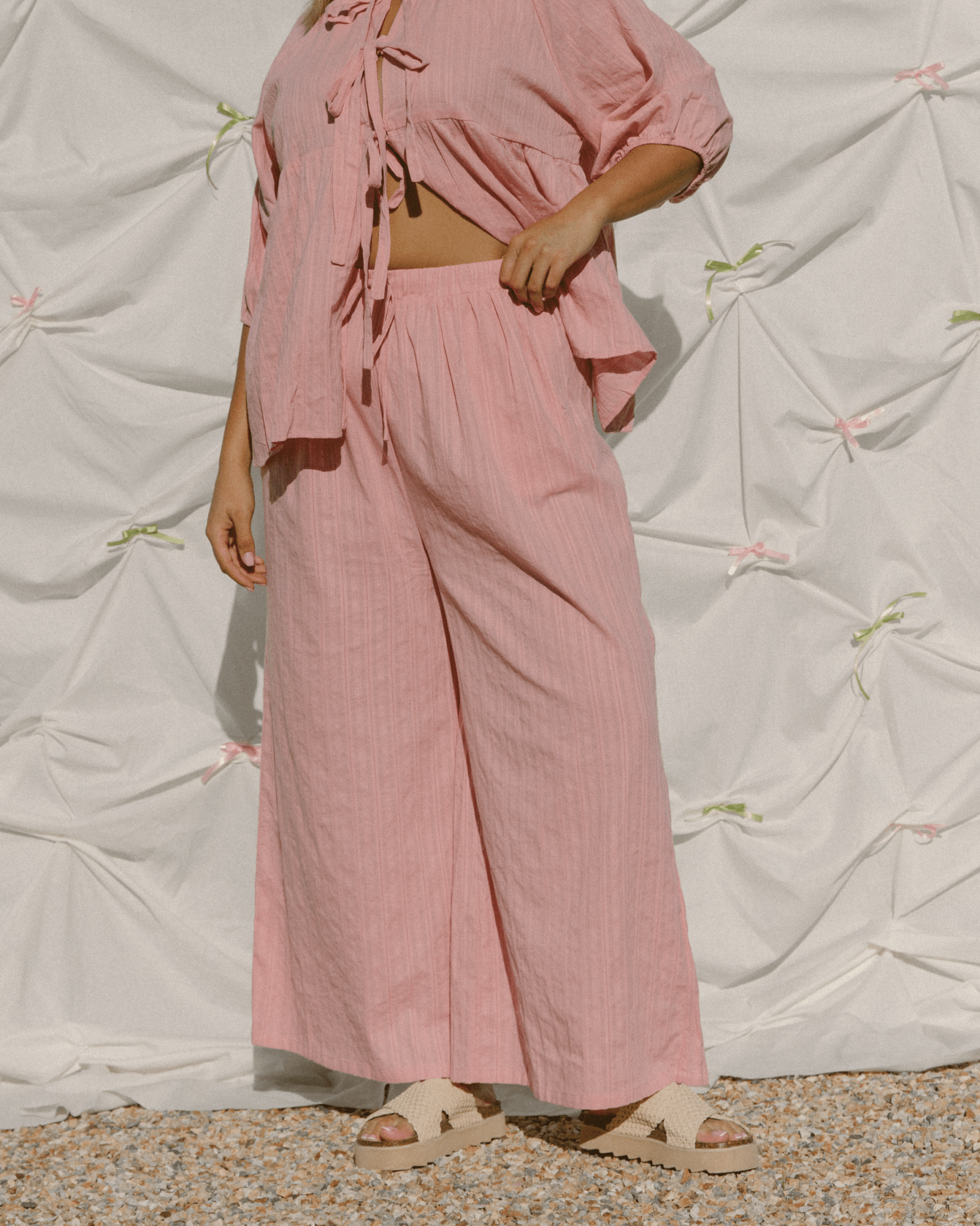 Woman wearing wide-legged comfy cotton pants.