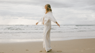 a pregnant woman in lounge wear on the beach 